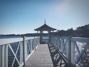 Pier over sea against clear sky