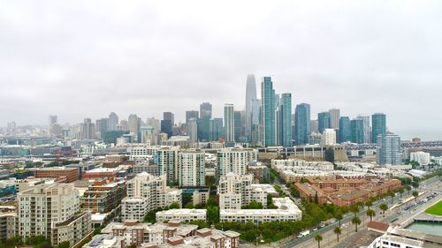 High angle view of modern buildings in city against sky