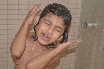 Close-up of girl dancing while taking bath