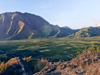 Scenic view of landscape and mountains against sky