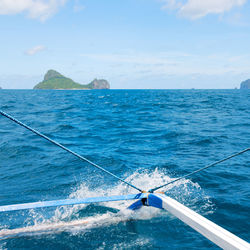 Sailboat sailing in sea against sky