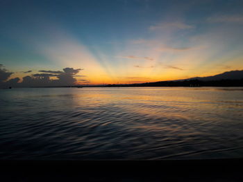 Scenic view of sea against sky at sunset