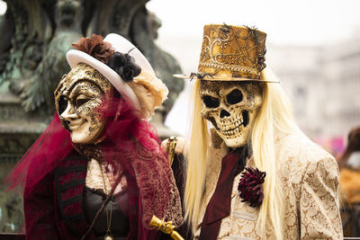 People wearing mask in traditional clothing