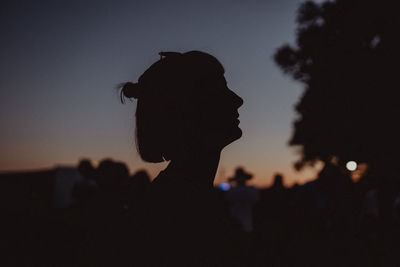 Silhouette woman against sky during sunset