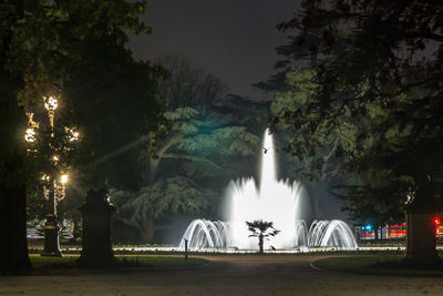 Fountain at park during night