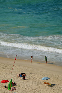 People on beach by sea