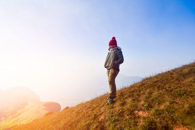 Man standing on landscape against sky