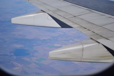 Airplane wing over landscape