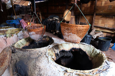 Salt in wicker baskets hanging over containers at workshop