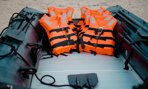High angle view of life jackets in boat at beach