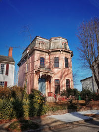 Low angle view of building against blue sky