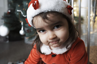 A mother and daughter decorate the christmas tree