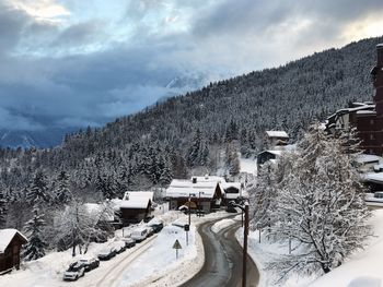 Panoramic view of snow covered mountains against sky