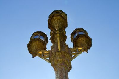 Low angle view of sculpture against clear blue sky