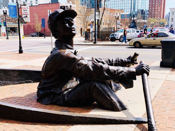 Statue on street in city