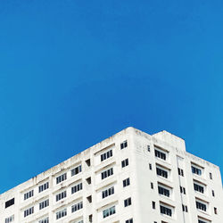 Low angle view of building against clear blue sky