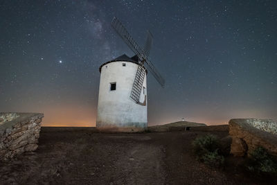 Traditional windmill against sky at night