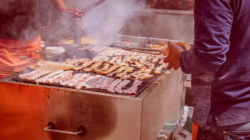 Man preparing food on barbecue grill