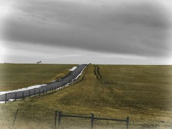 Scenic view of landscape against cloudy sky
