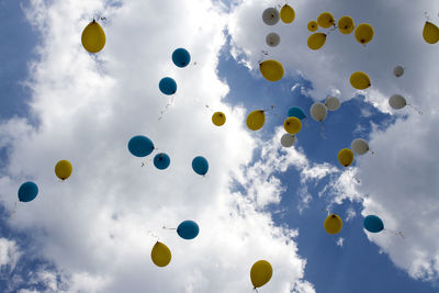 Low angle view of balloons against sky