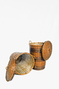 Close-up of shells on wicker basket against white background