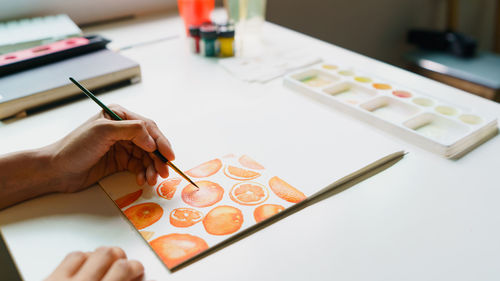 Midsection of businessman working on table