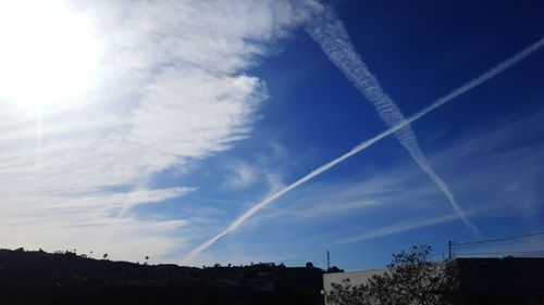 Low angle view of vapor trails in sky