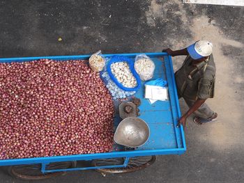 High angle view of vendor selling onions on street