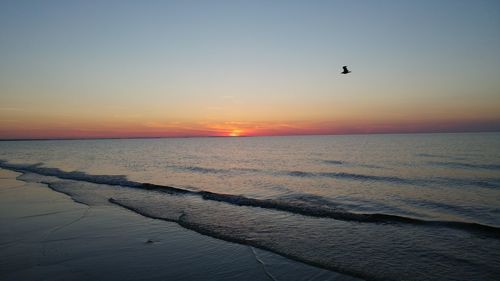 Scenic view of sea against clear sky during sunset