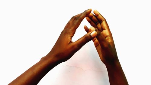 Close-up of hand against white background