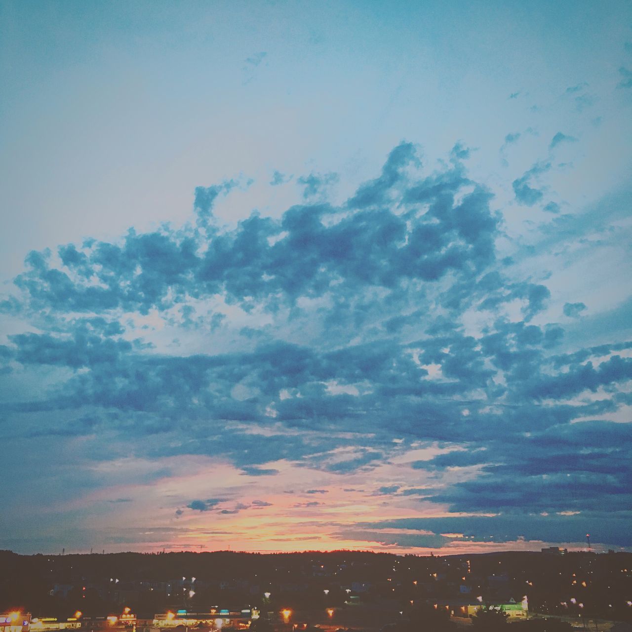 sky, scenics, cloud - sky, city, cityscape, beauty in nature, landscape, sunset, nature, blue, tranquil scene, tranquility, outdoors, mountain, cloud, no people, idyllic, residential district, town, illuminated, cloudy, weather, horizon over land, city life