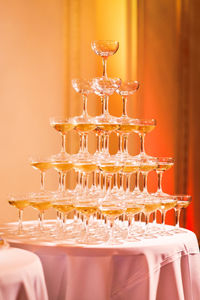 Pyramid of champagne glasses on table at wedding