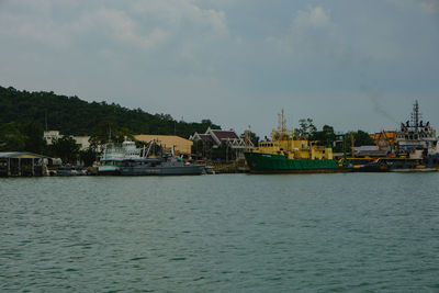 Scenic view of sea by buildings against sky