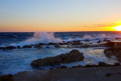 Scenic view of sea against clear sky during sunset