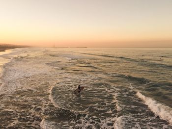 Scenic view of sea against clear sky during sunset