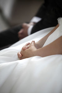 Hands of a bride and a groom in church
