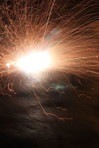 Low angle view of firework display at night