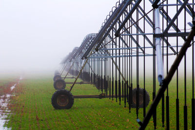 Agricultural machinery in farm against sky