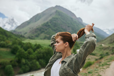 Portrait of young man standing on mountain