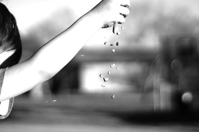 Cropped image of kid dropping stones