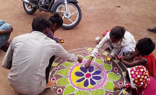 High angle view of people sitting on bicycle