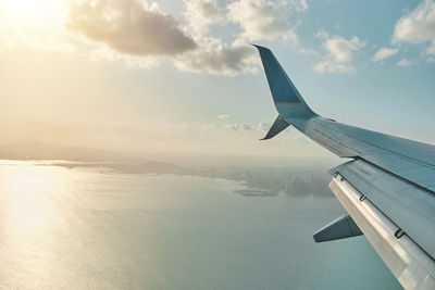 View from the airplane window on a beautiful sunset and clouds of panama city