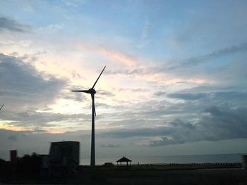 Windmill against sky at sunset
