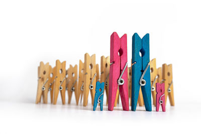 Close-up of clothespins on clothesline against white background