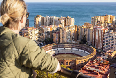 Side view of man standing on city