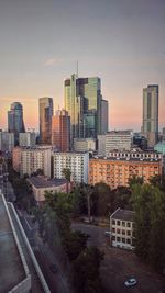 City buildings against sky during sunset