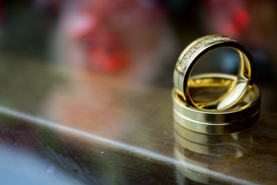 Close-up of golden wedding rings on table