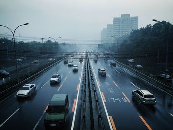 Traffic on city street against sky