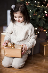 Cute girl holding christmas gift
