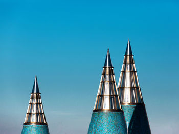 Low angle view of modern buildings against blue sky